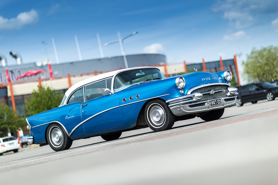 blue vintage car on the road